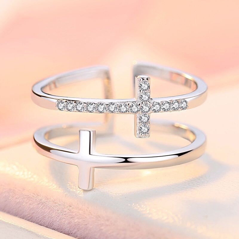 Adjustable double cross zircon inlaid silver ring featuring a silver cross design with pave diamonds and an adjustable band.