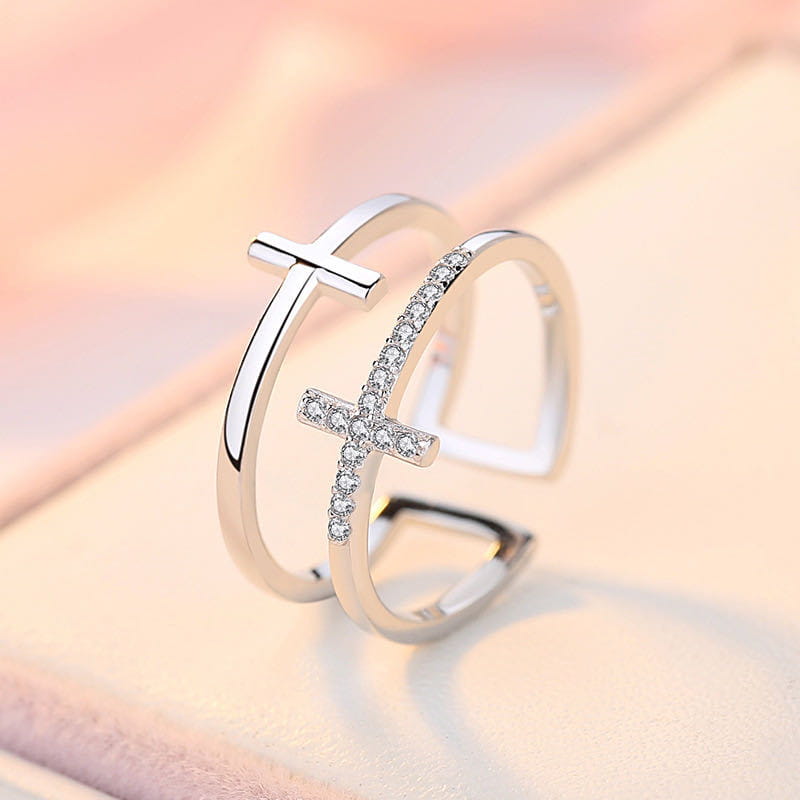 A sleek silver adjustable double cross ring featuring a pave diamond band and an open design with zircon inlays.