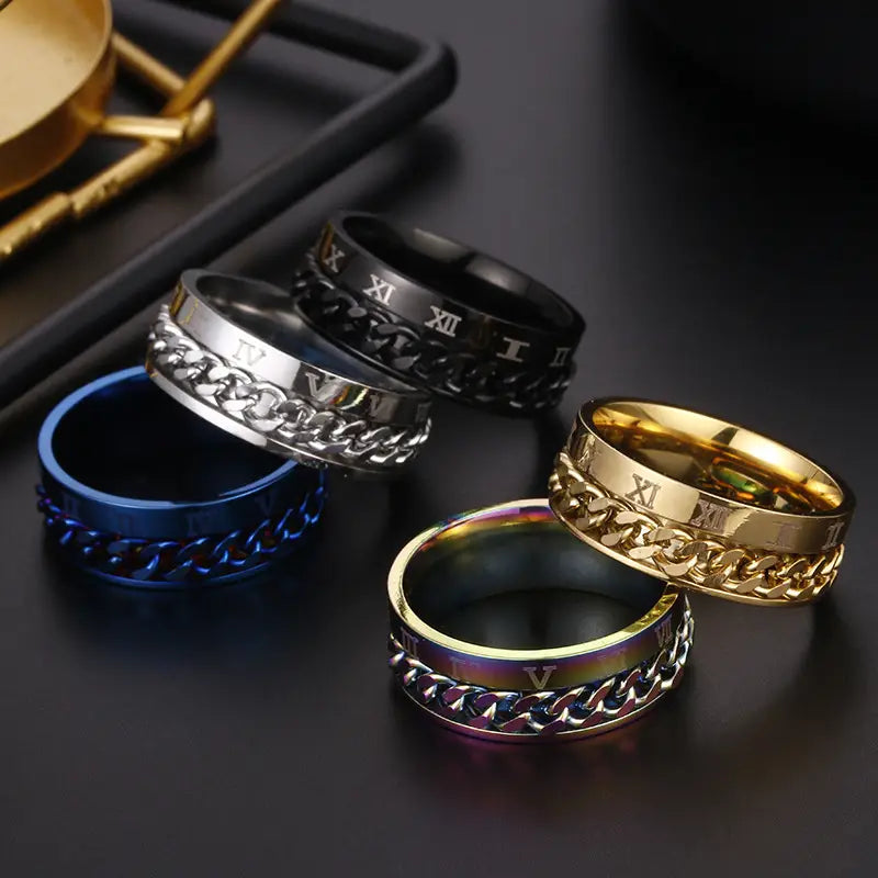 Set of five stainless steel roman numeral spinner chain rings with bottle opener feature in black silver gold blue and rainbow finish.