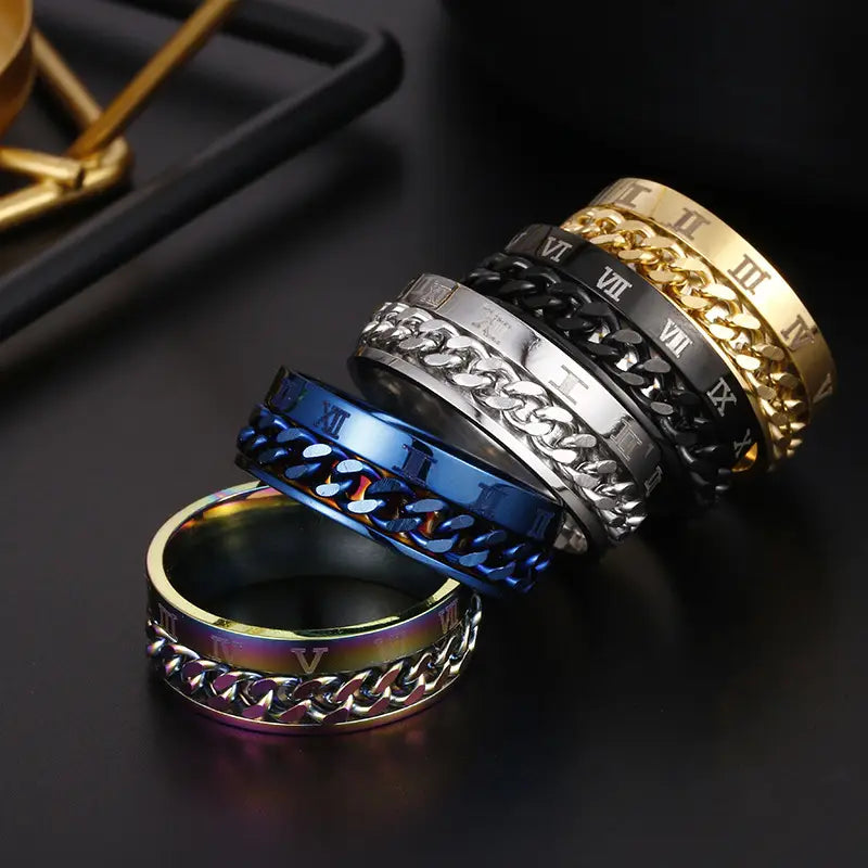 Set of stainless steel roman numeral spinner chain rings with bottle opener feature in gold silver black and blue colors.