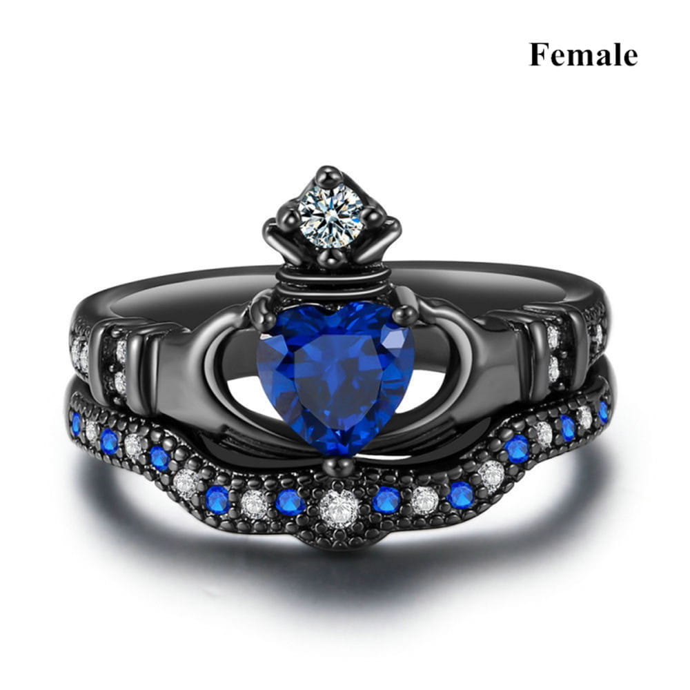 Black titanium blue heart sapphire claddagh wedding ring set featuring an engagement ring with a prominent heart-shaped blue gemstone surrounded by smaller blue and clear stones in an ornate design.