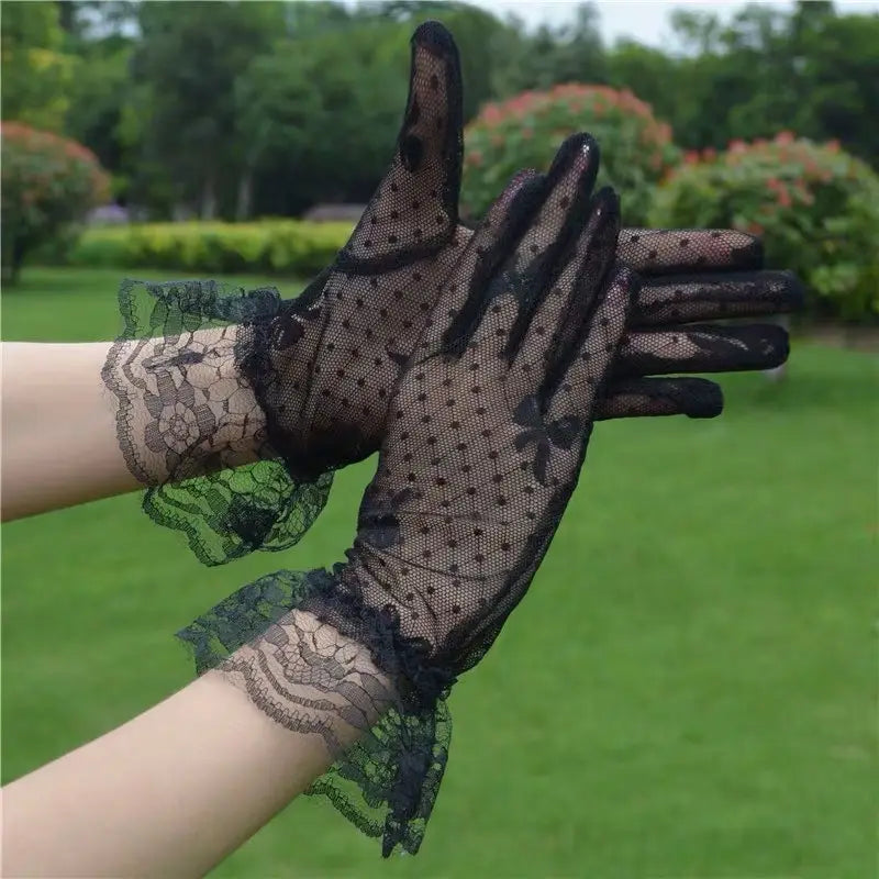 Elegant black floral lace ruffled bow gloves featuring delicate floral patterns and ruffled cuffs.