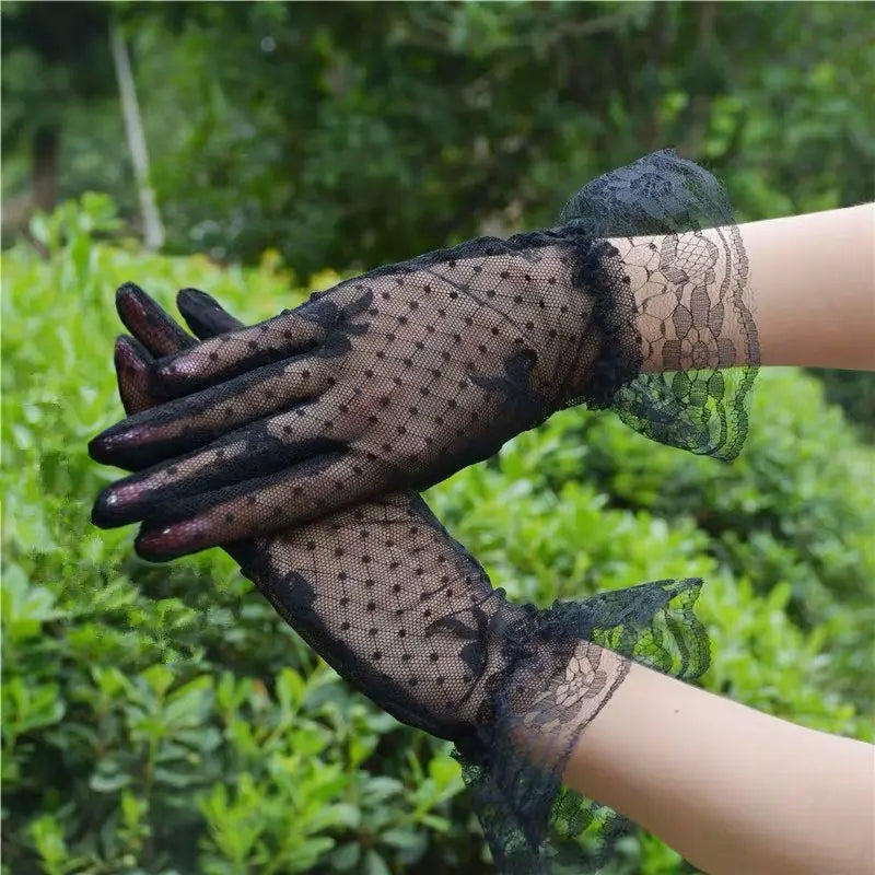 Elegant black floral lace ruffled bow gloves featuring delicate floral patterns and ruffled cuffs.