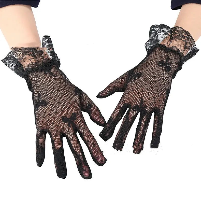 Elegant black floral lace ruffled bow gloves featuring delicate floral patterns and a ruffled cuff shown from the back side.