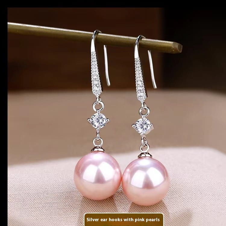 Elegant pearl and pave diamond drop earrings feature silver dangle design with pave-set crystal hooks, central round-cut diamonds, and pink freshwater pearl drops.