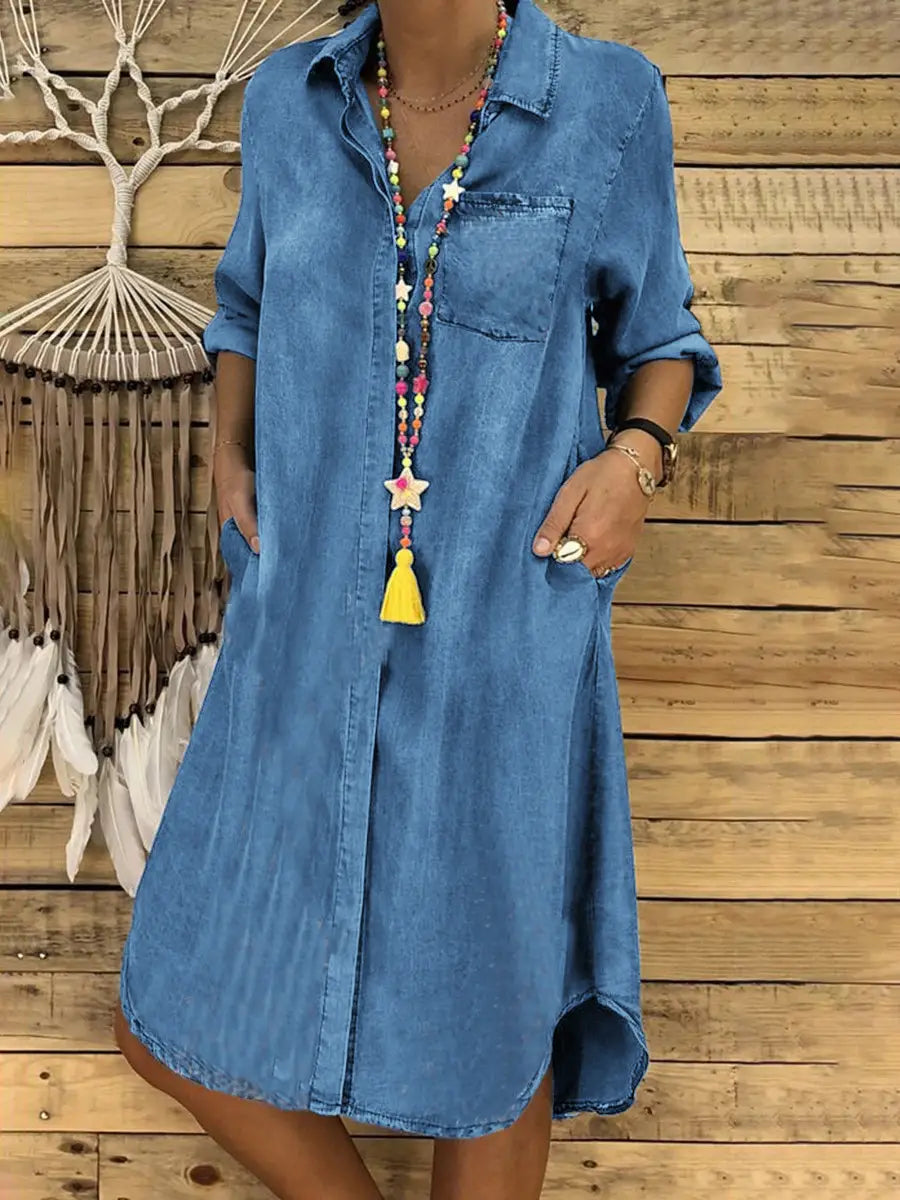 Blue denim shirt dress for women featuring a button front, rolled-up sleeves, and a front pocket.
