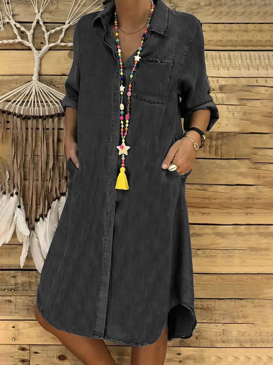 Dark gray denim button front shirt dress for women with rolled sleeves and front pockets.