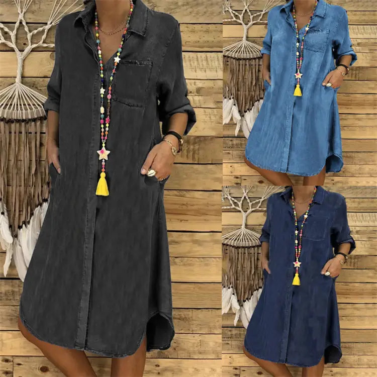Women’s button front denim shirt dress with rolled sleeves in dark gray medium blue and navy hues featuring chest pocket and asymmetrical hem.