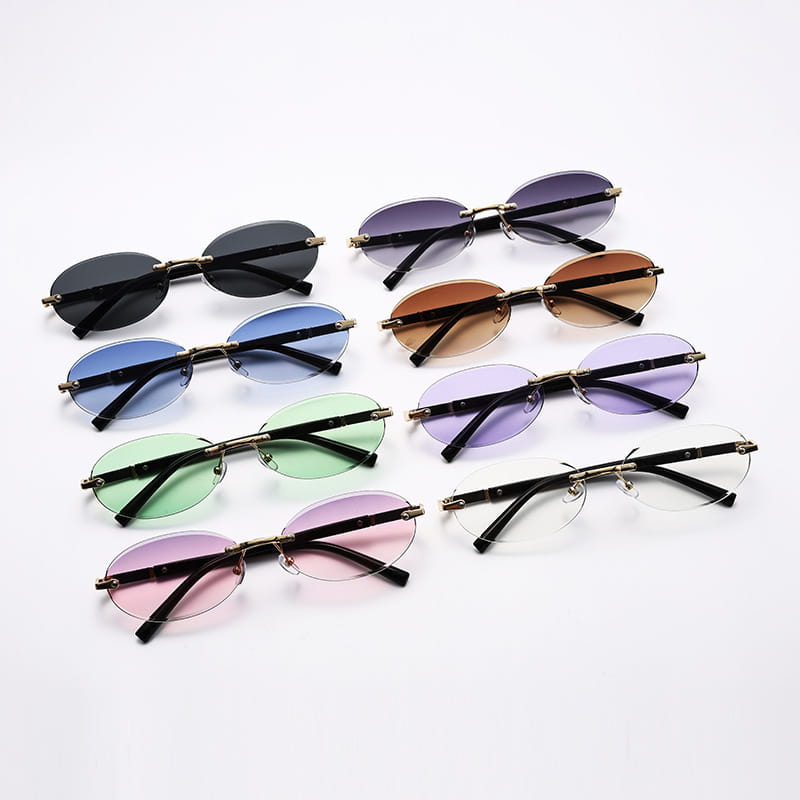 A set of stylish frameless oval uv400 fashion sunglasses with metal accents featuring rimless gradient-tinted lenses in black blue green pink and clear colors.