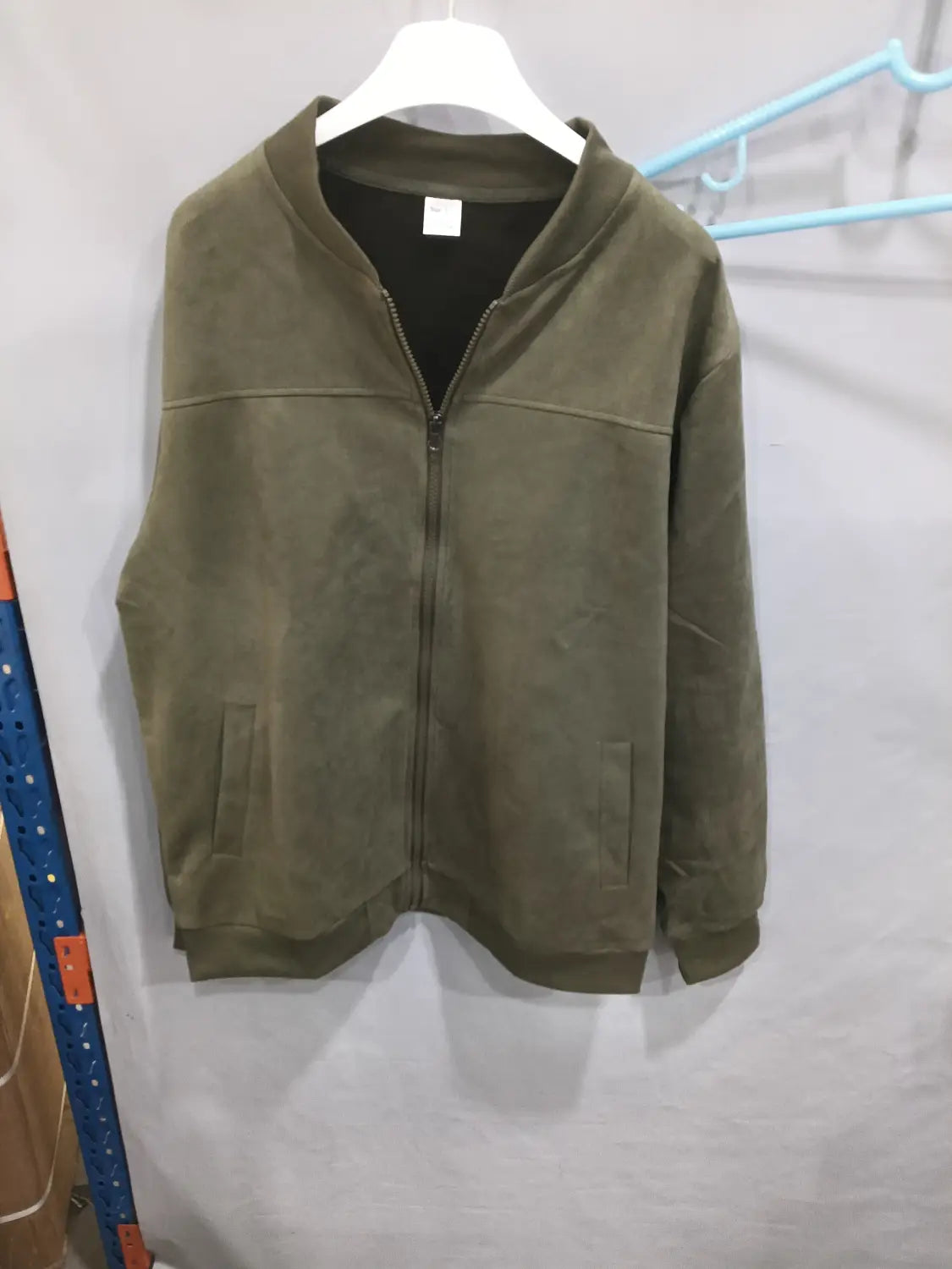 Men suede casual retro jacket in olive green suede with black inner lining zip-up design and two front pockets.