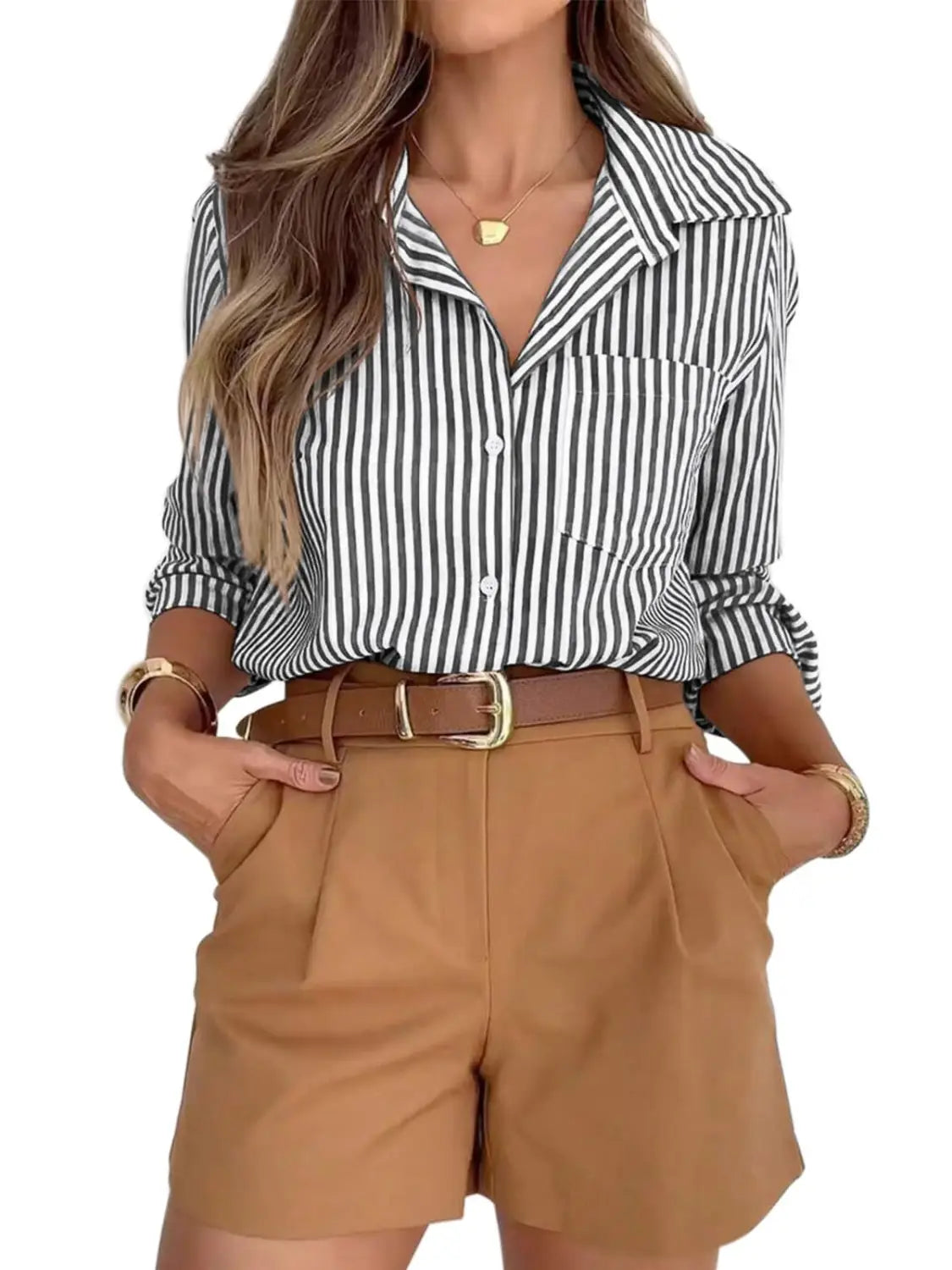 A stylish black and white vertically striped long sleeve button up shirt dress with rolled sleeves for women.