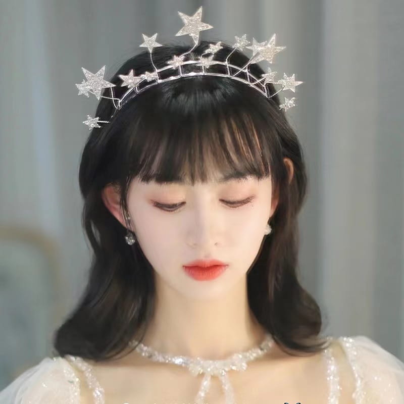 Silver star tiara adorned with sparkling rhinestones and delicate metalwork for bridal use in a crystal star bridal tiara silver rhinestone wedding crown.