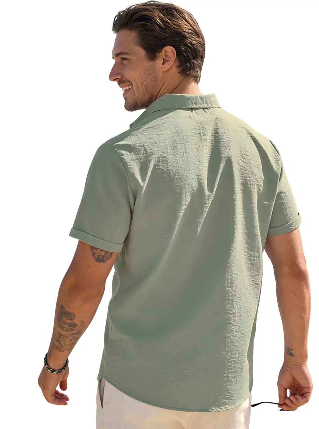 A light green men’s textured bamboo linen short sleeve button down shirt with rolled cuffs and textured fabric.