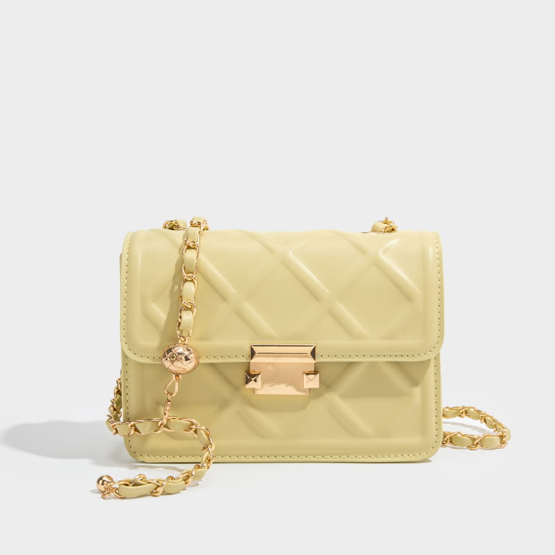 A glossy pale yellow quilted crossbody bag with gold-tone chain straps and a matching metallic clasp.