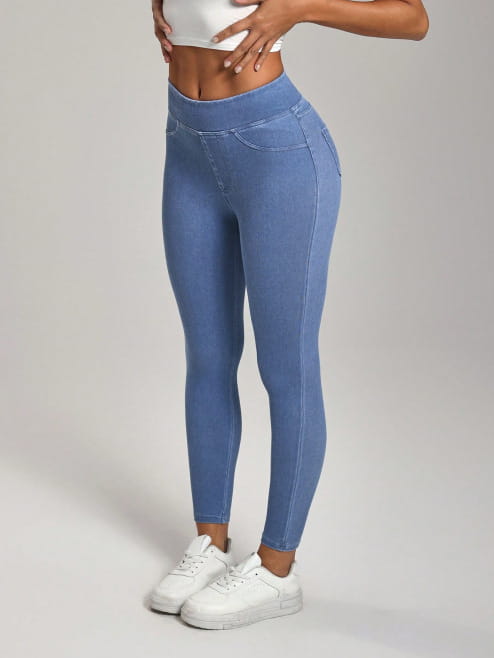 Blaue Jeansleggings mit hoher Taille, eng anliegender Passform und dezenten Ziernähten, entworfen als schlank machende Sporthose.