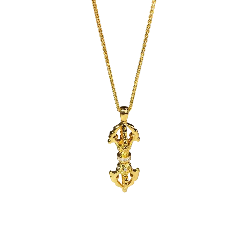 Golden tibetan prayer wheel pendant with intricate detailing and diamonds on a 24k gold vajra diamond necklace