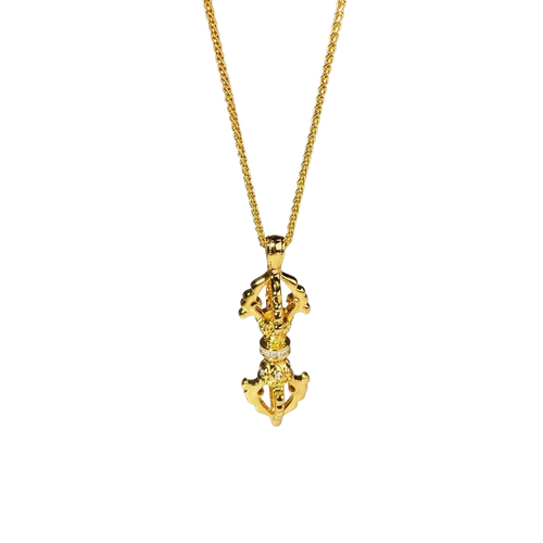 Golden tibetan prayer wheel pendant with intricate detailing and diamonds on a 24k gold vajra diamond necklace