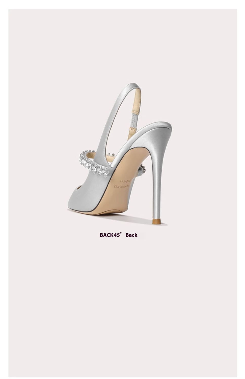 Silver satin slingback pointed toe high heel featuring a jeweled strap detail.