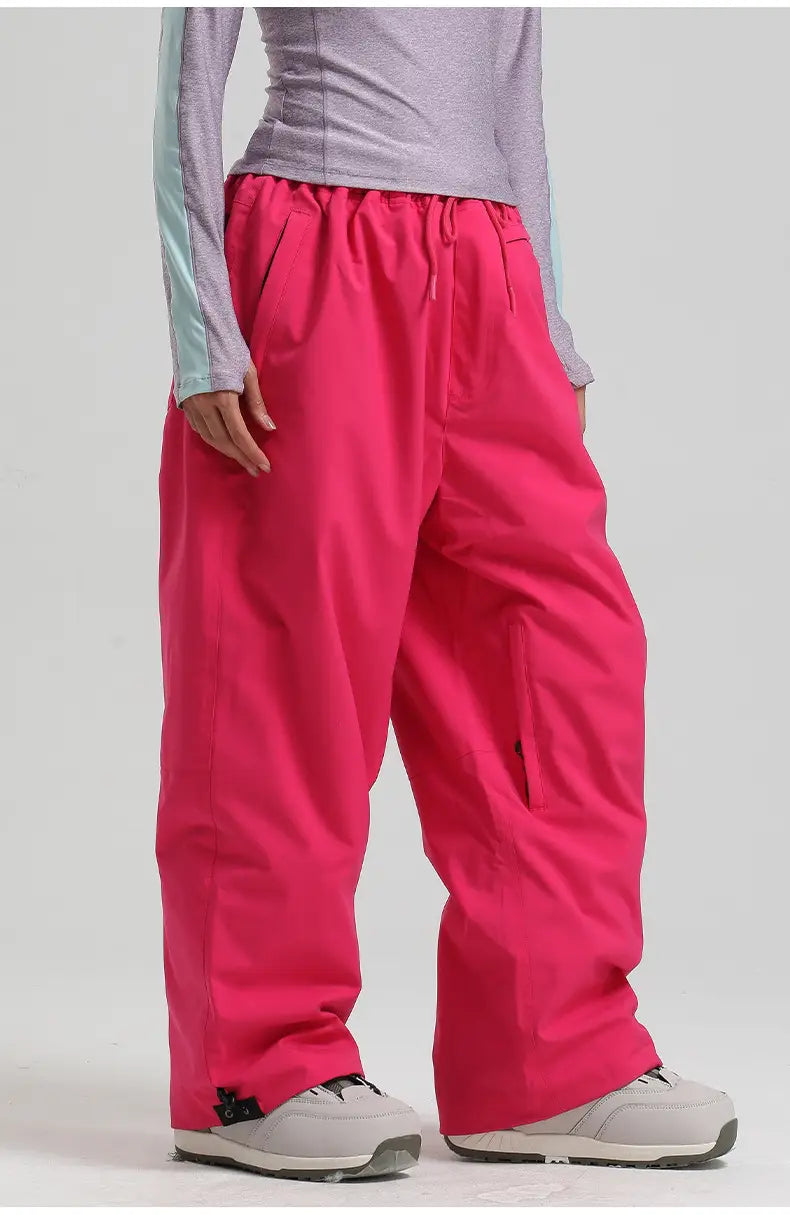 Bright pink wide-leg waterproof windproof snow pants with an elastic waistband and side pockets designed as loose work trousers.