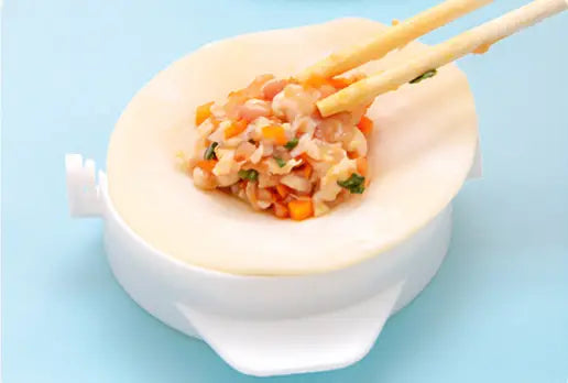 white plastic dumpling maker 3 in 1 manual dough pressing tool with circular mold and handle filled with colorful vegetable filling pressed by chopsticks