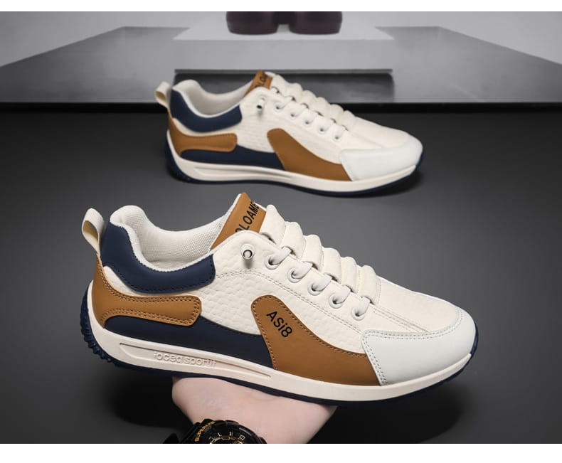 Men’s casual sports sneakers in white tan and navy blue featuring a textured microfiber upper and non-slip rubber sole.