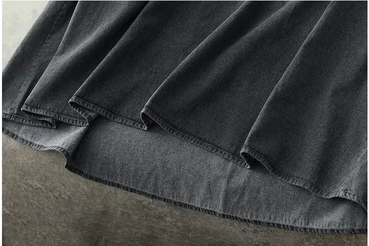 Retro artistic plus size dark gray denim tunic dress featuring dark gray denim fabric with a slightly worn faded texture and visible stitching along the hem.
