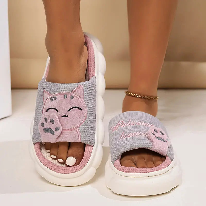 Pink and gray embroidered cat cartoon unisex slide slippers with a plush cushioned design and anti-slip soles.