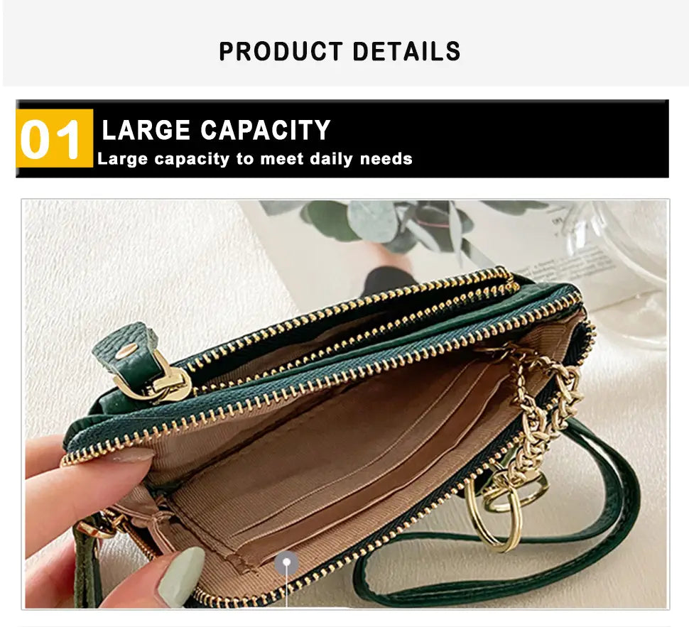 Green leather wristlet wallet with premium textured leather, gold-tone zippers, and chain strap featuring gold hardware.
