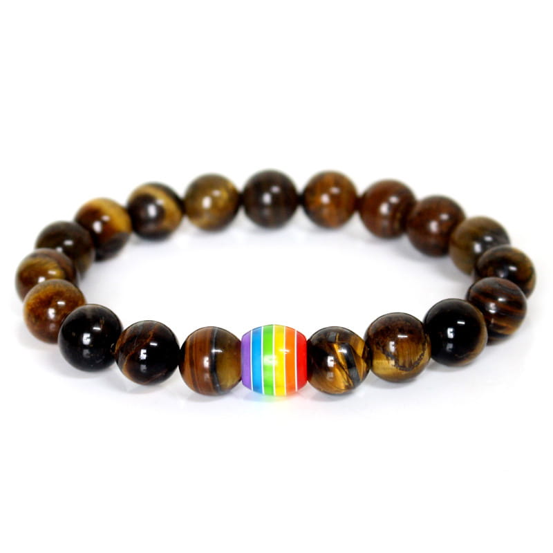 A stretchy bracelet made of polished tiger eye beads featuring a single rainbow-striped accent bead representing pride.