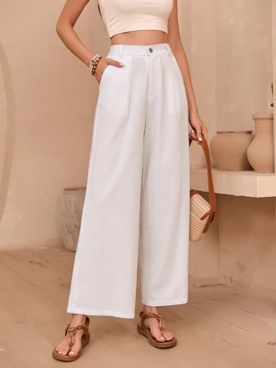 White linen wide leg high waisted pants featuring a clean minimalist design and wide leg silhouette.