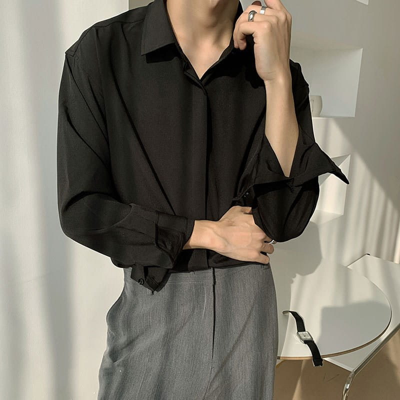 Black long-sleeved retro drape wrinkle resistant satin button down shirt with relaxed fit and rolled cuffs.