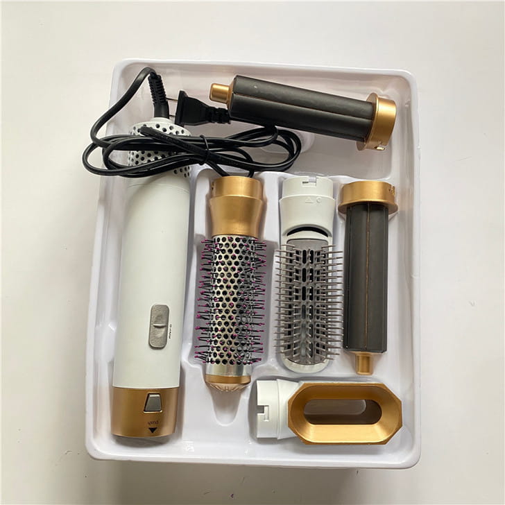white and gold electric 5-in-1 hot air comb hair dryer and styler set with multiple attachments for versatile hair styling