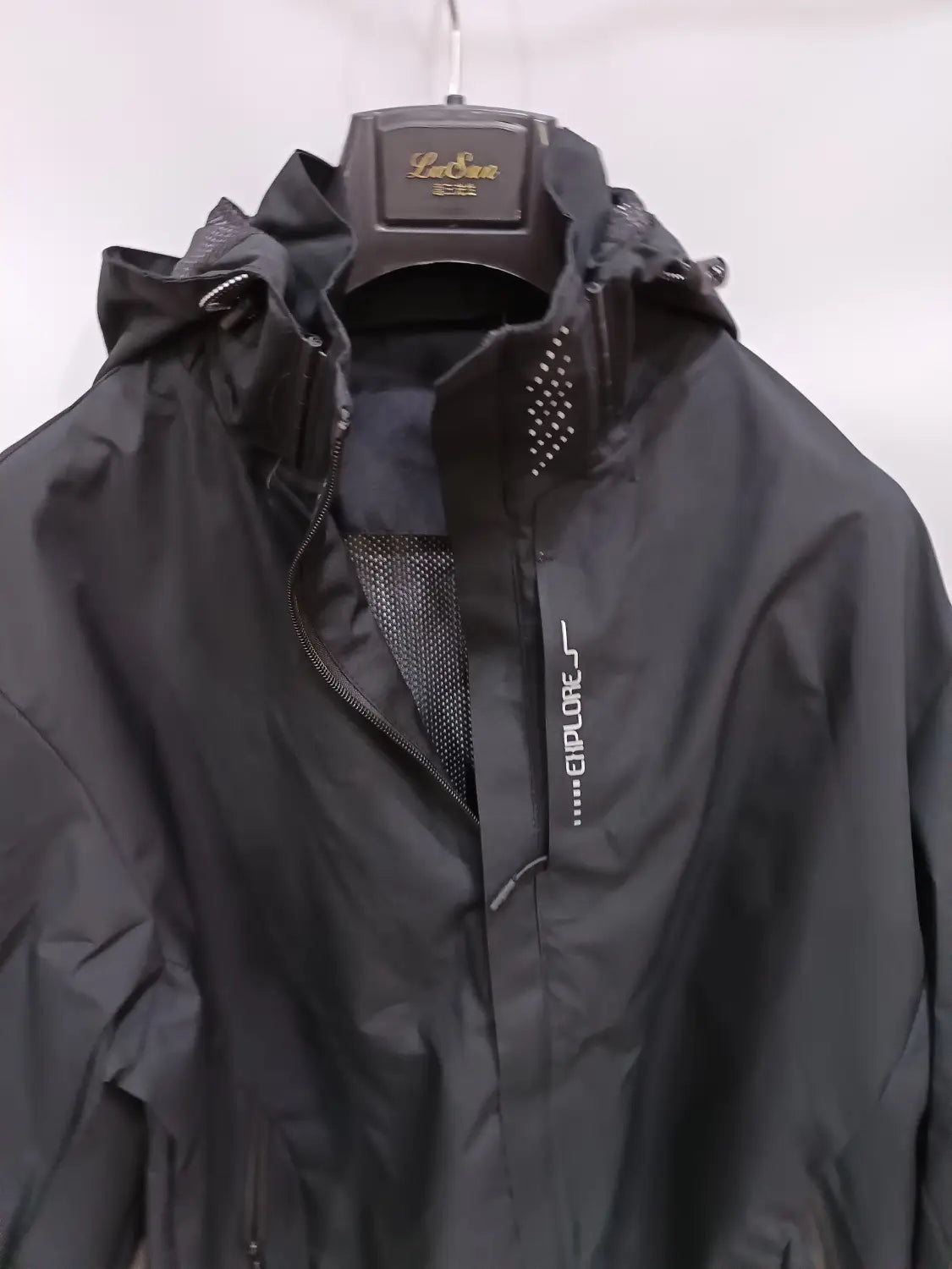 Black lasua explorer waterproof hiking jacket men hooded windbreaker with mesh lining and subtle white branding on the chest.