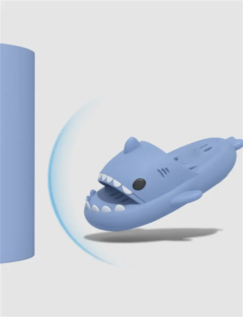 Light blue shark-shaped non slip quick dry shower slide slipper with white teeth black eye and soft rubber material.