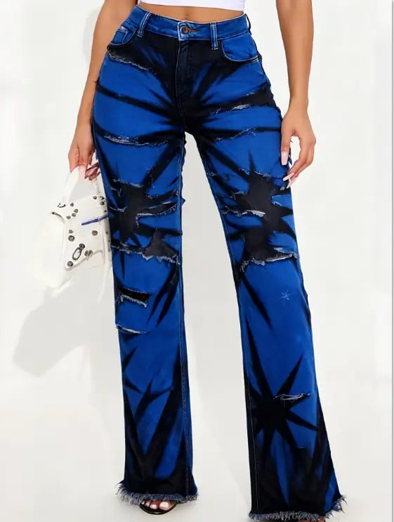 Two tone distressed wide leg jeans in vibrant royal blue denim with bold black starburst patterns and frayed edges.