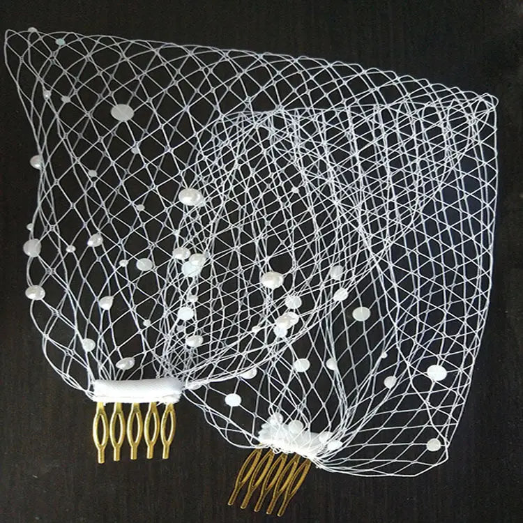 Short pearl beaded mesh bridal veil in white with gold-colored comb attachments.