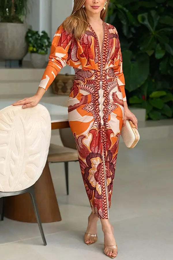 a vibrant orange and red printed v-neck geometric wrap midi dress with long sleeves and a fitted waist