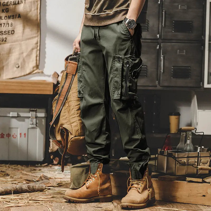 Men tactical cargo pants in olive green with multiple pockets and a drawstring waistband designed for outdoor casual utility use.