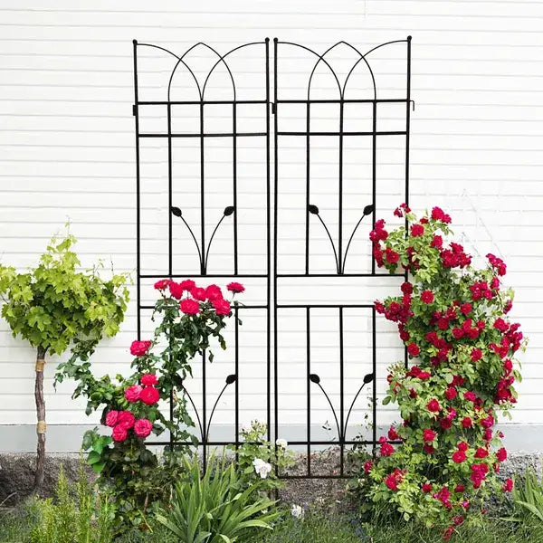 Black wrought iron garden trellis with arched top and decorative leaf motifs metal garden trellis 2 pack with rose decor 71 inch.