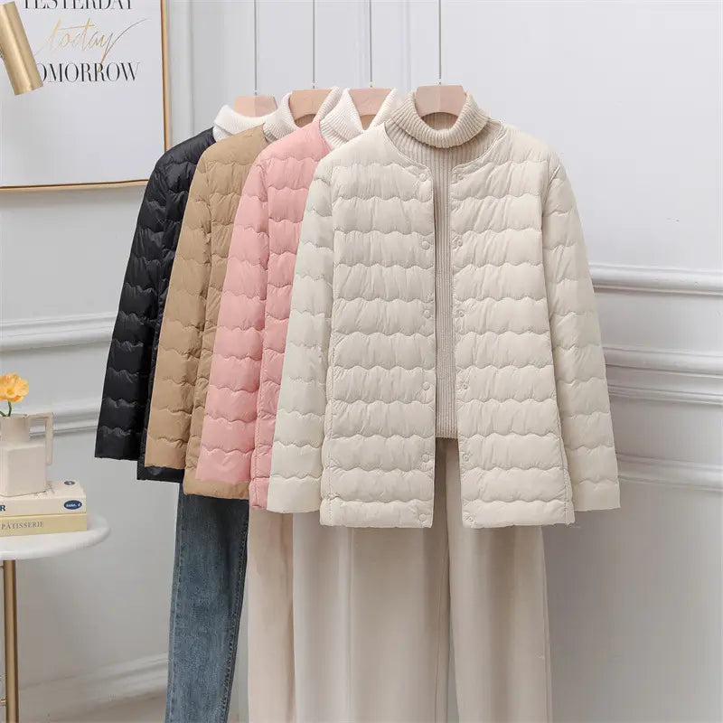 Cream-colored quilted puffer jacket with a high collar and button closure from the Puff Jacket Ruffled Crew Neck collection.