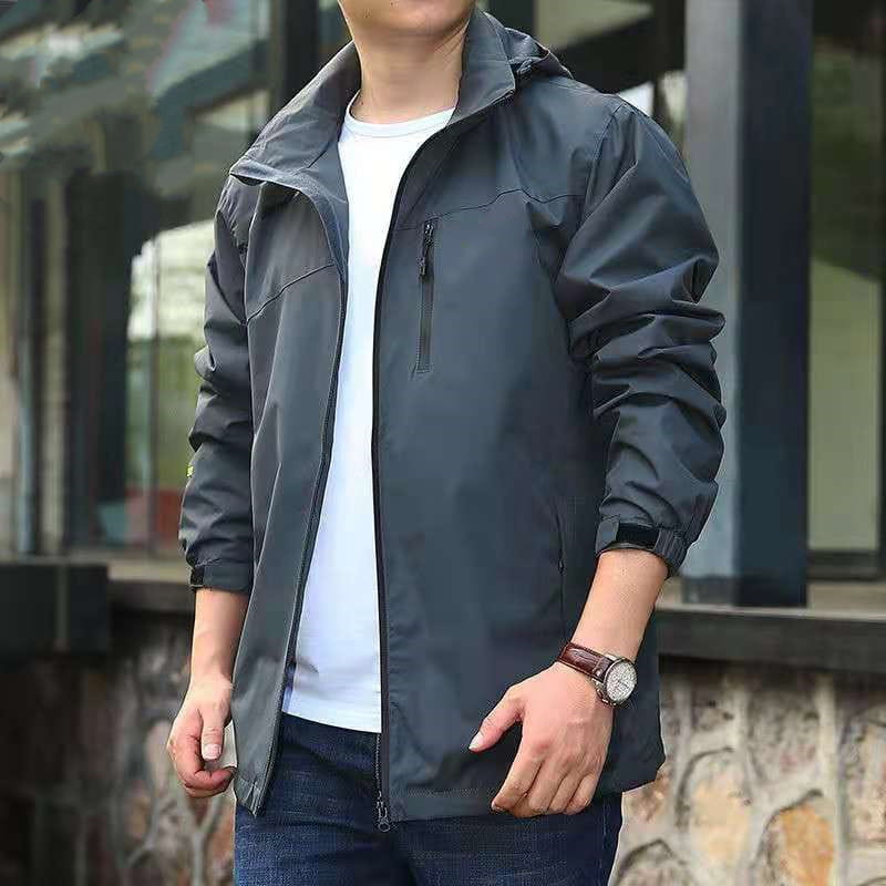 Dark gray lightweight nylon men waterproof hiking jacket with a hood and zippered pockets.