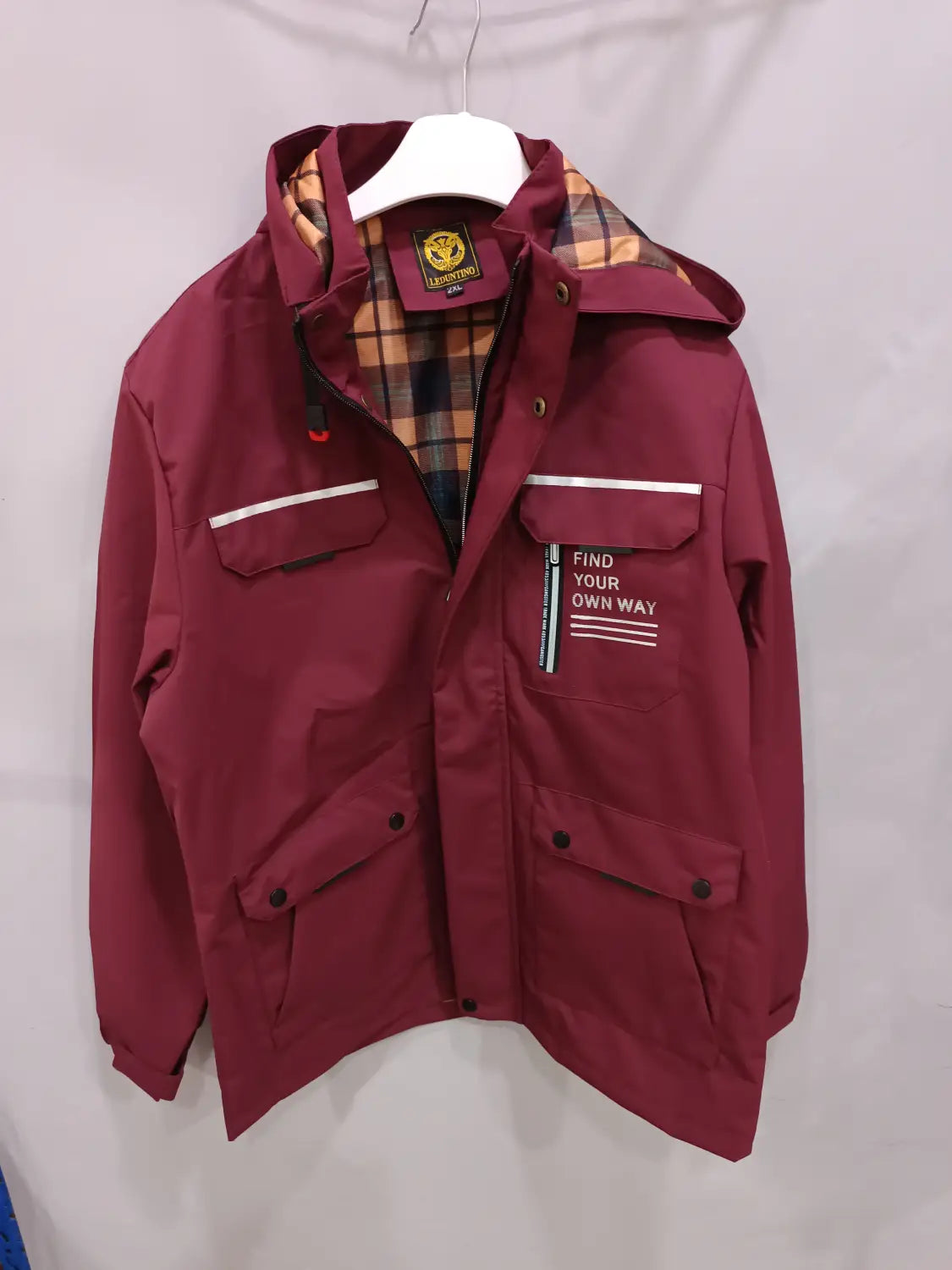 Men winter hooded parka coat in maroon with plaid lining and a white text patch on the chest pocket.