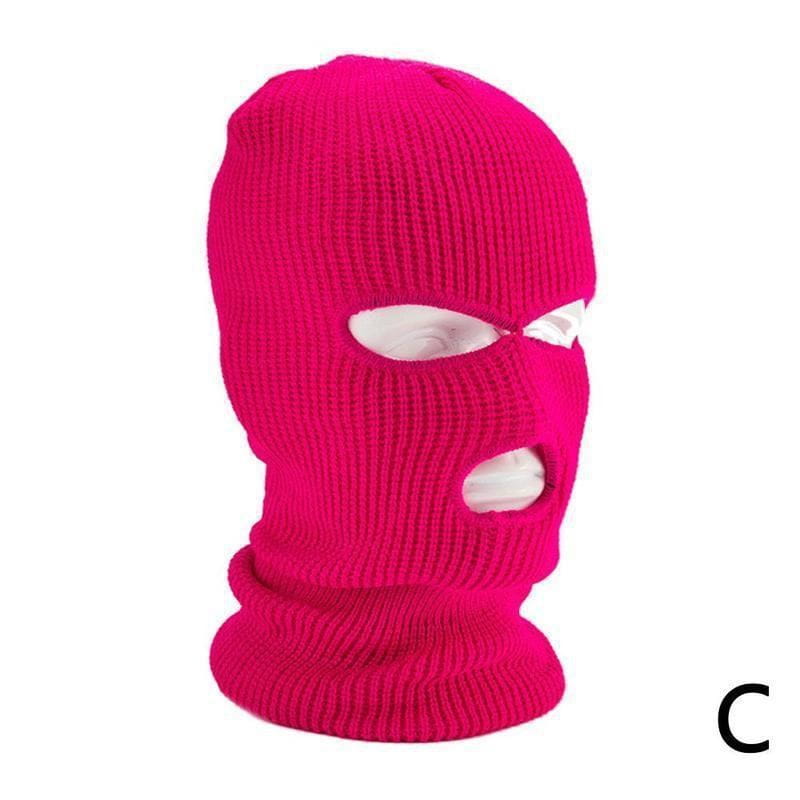 Bonnet cagoule en maille rose vibrant à côtes, avec des ouvertures pour les yeux et la bouche, conçu comme un masque chaud pour le cyclisme.