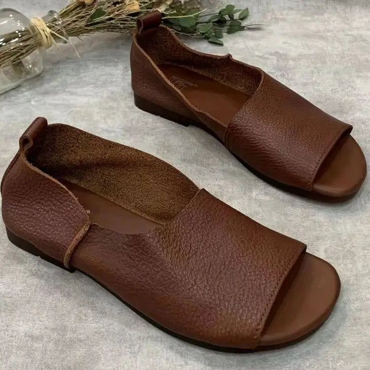 Brown leather slip-on sandals featuring a retro soft sole and peep-toe design with a soft textured surface.