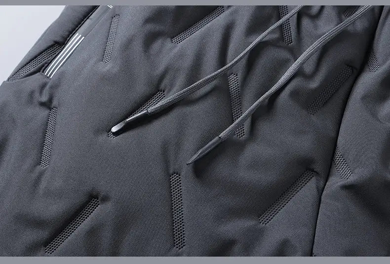 dark gray thermal fleece lined winter joggers featuring a matching hoodie with mesh ventilation panels and drawstrings for enhanced breathability and comfort.