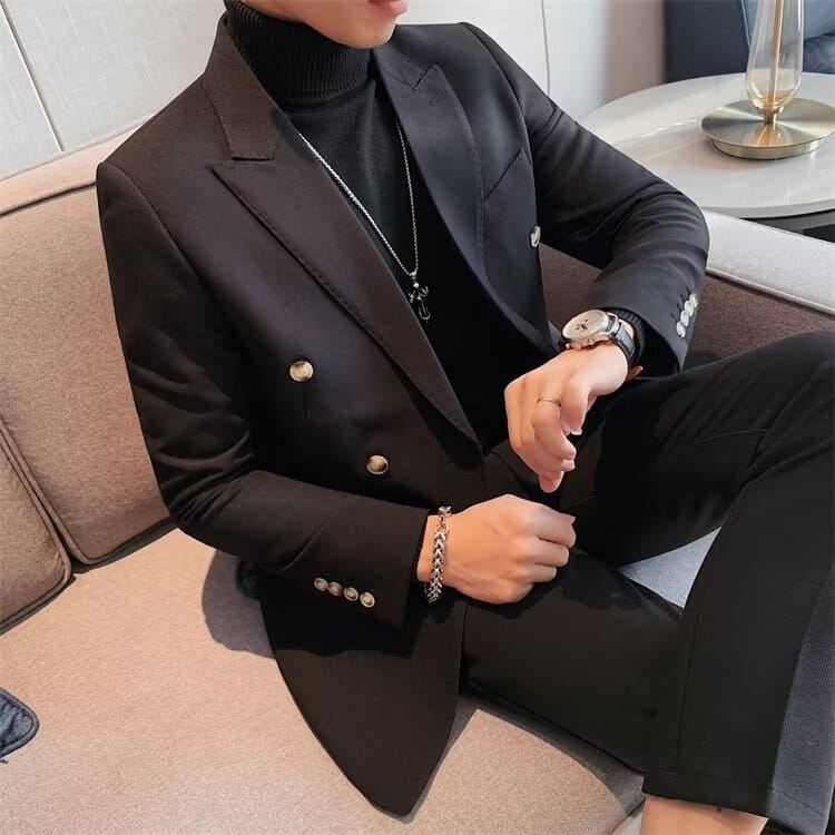 Black double-breasted suit jacket with gold-toned buttons and a sleek tailored fit contrasted with a teal double-breasted corduroy jacket for men.