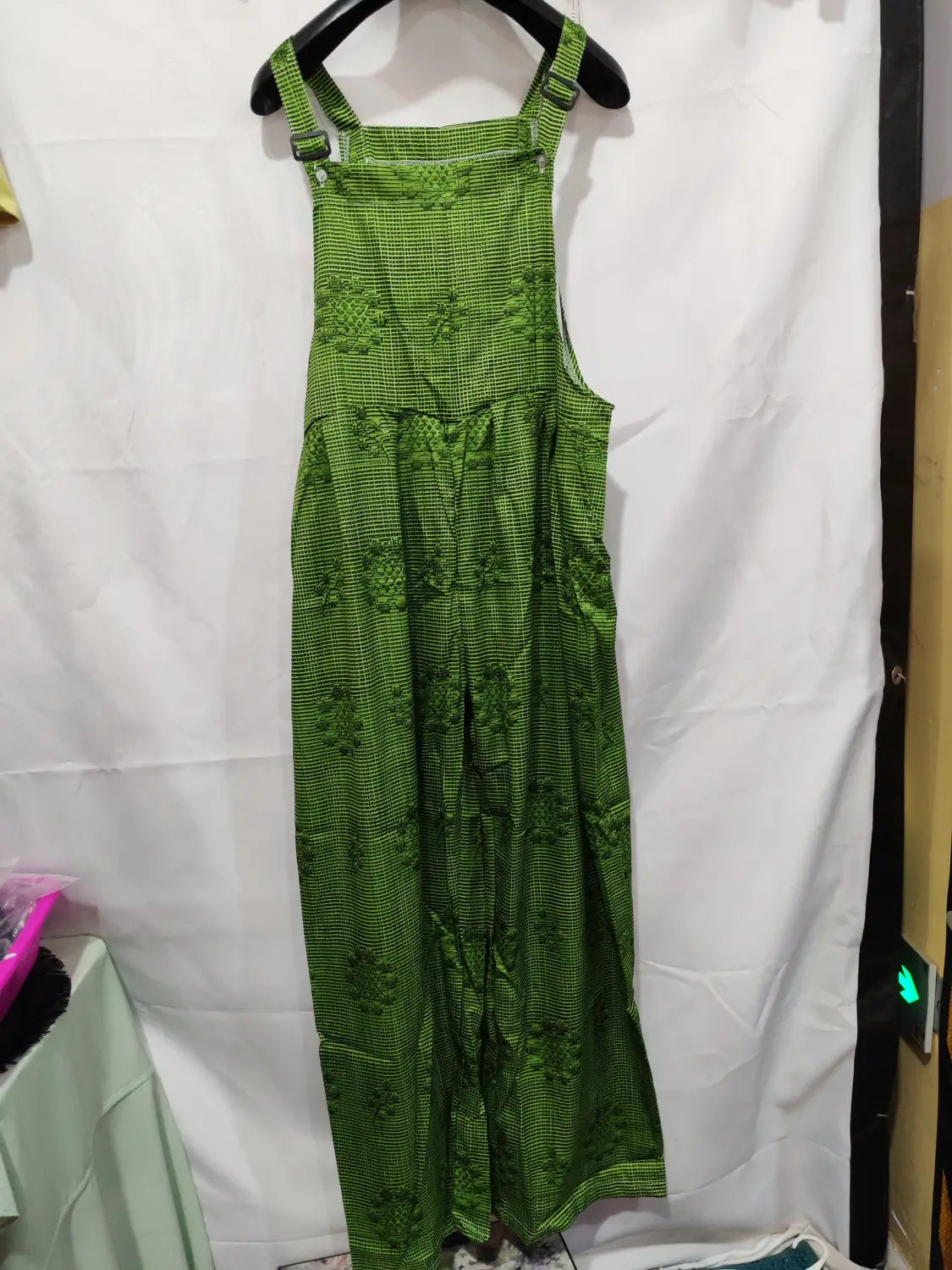 Green patterned suspender pants with a checkered base and floral embroidery featuring 3d printed buttons for casual wear.