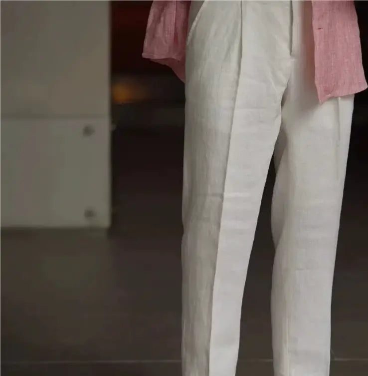 High waisted white linen trousers for men featuring a subtle texture and a clean straight leg cut.