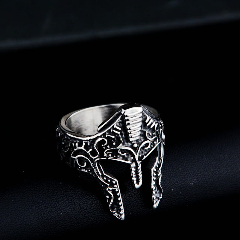 Silver spartan warrior helmet engraved stainless steel ring with intricate engraved details and a textured metallic finish.