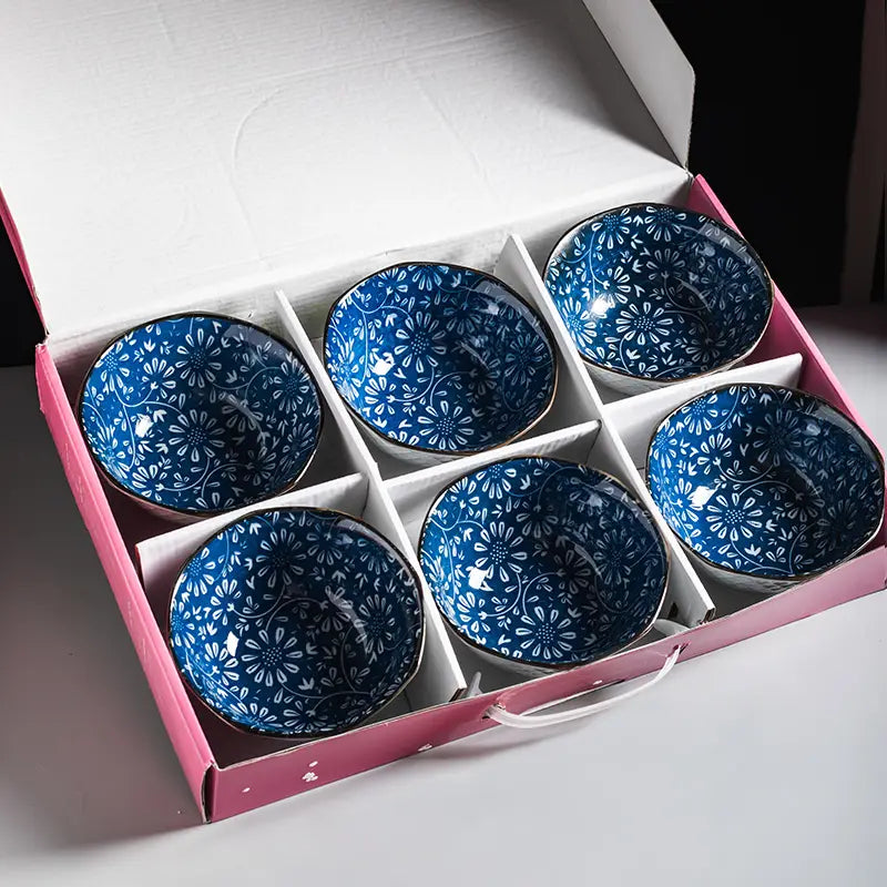 Set of six blue ceramic bowls with white floral patterns and gold rims neatly arranged in a pink gift box porcelain 5 inch.
